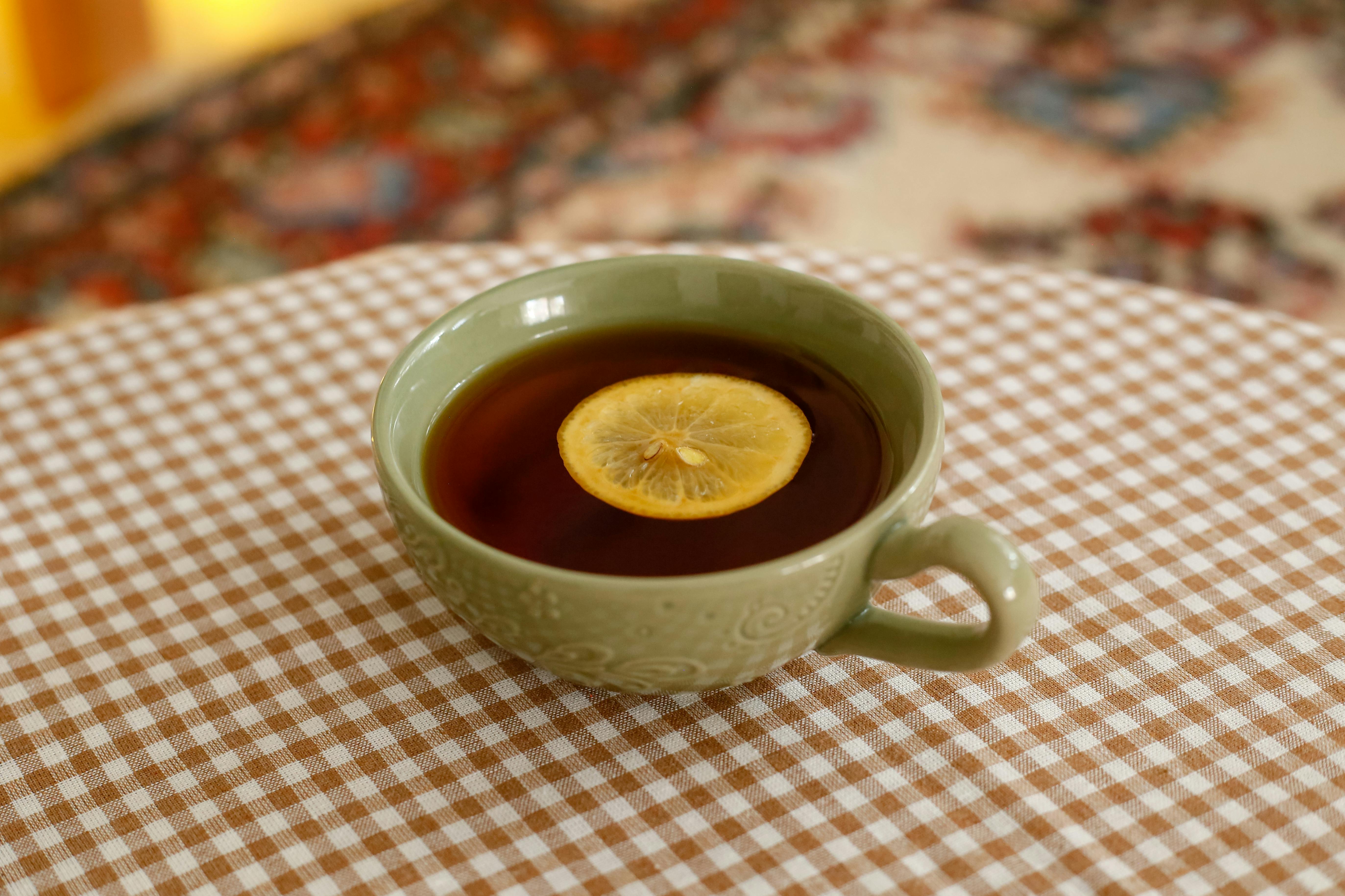 Earl Grey Tea In A Cup With Bergamot And Lemon Slices On A Wooden Table