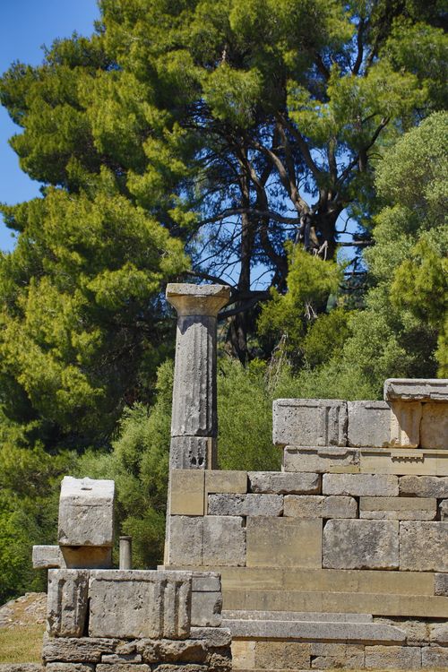 Free Explore the serene beauty of ancient Greek ruins set against a backdrop of vibrant trees. Stock Photo