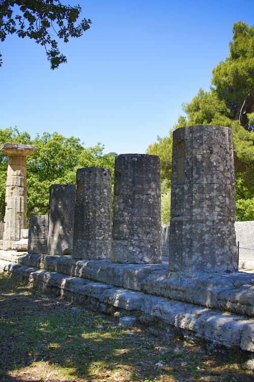 Free Ancient stone columns of Olympia's temple ruins under clear blue sky. Stock Photo