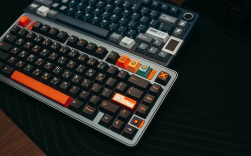 Free Close-up of colorful mechanical keyboards on a desk, showcasing unique keycaps and modern design. Stock Photo