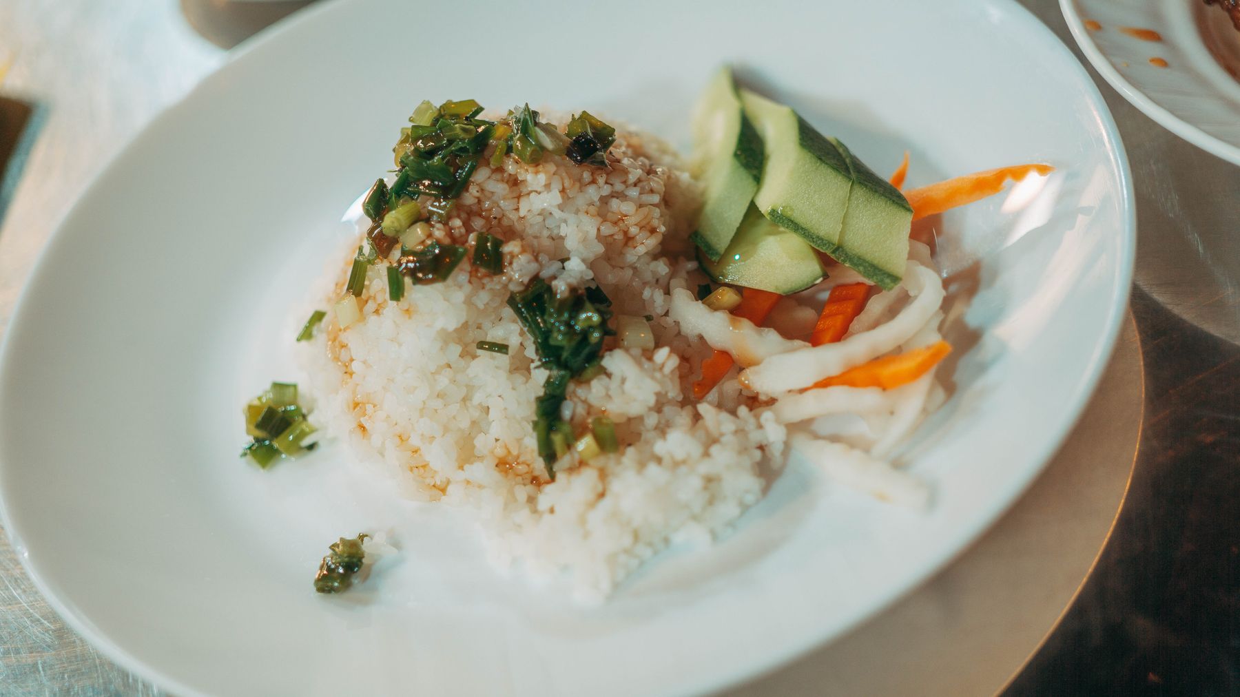 Delicious rice dish topped with herbs and vegetables, perfect for a refreshing meal.