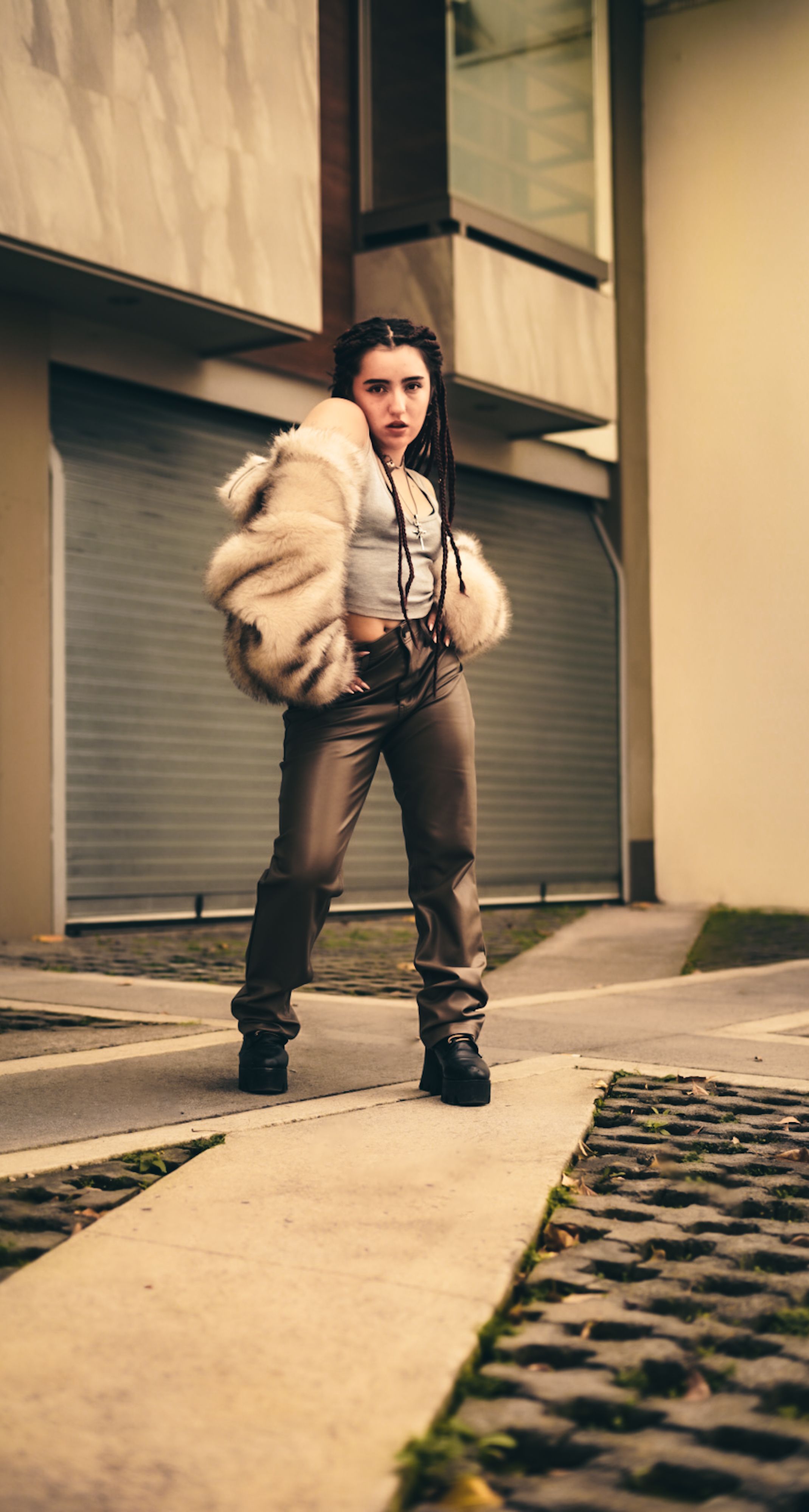Mulher elegante em traje da moda posa com confiança em uma cidade moderna.