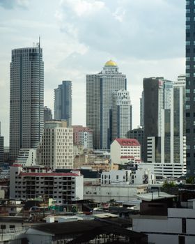 A stunning view of Bangkok's modern skyline featuring iconic skyscrapers under a cloudy sky.