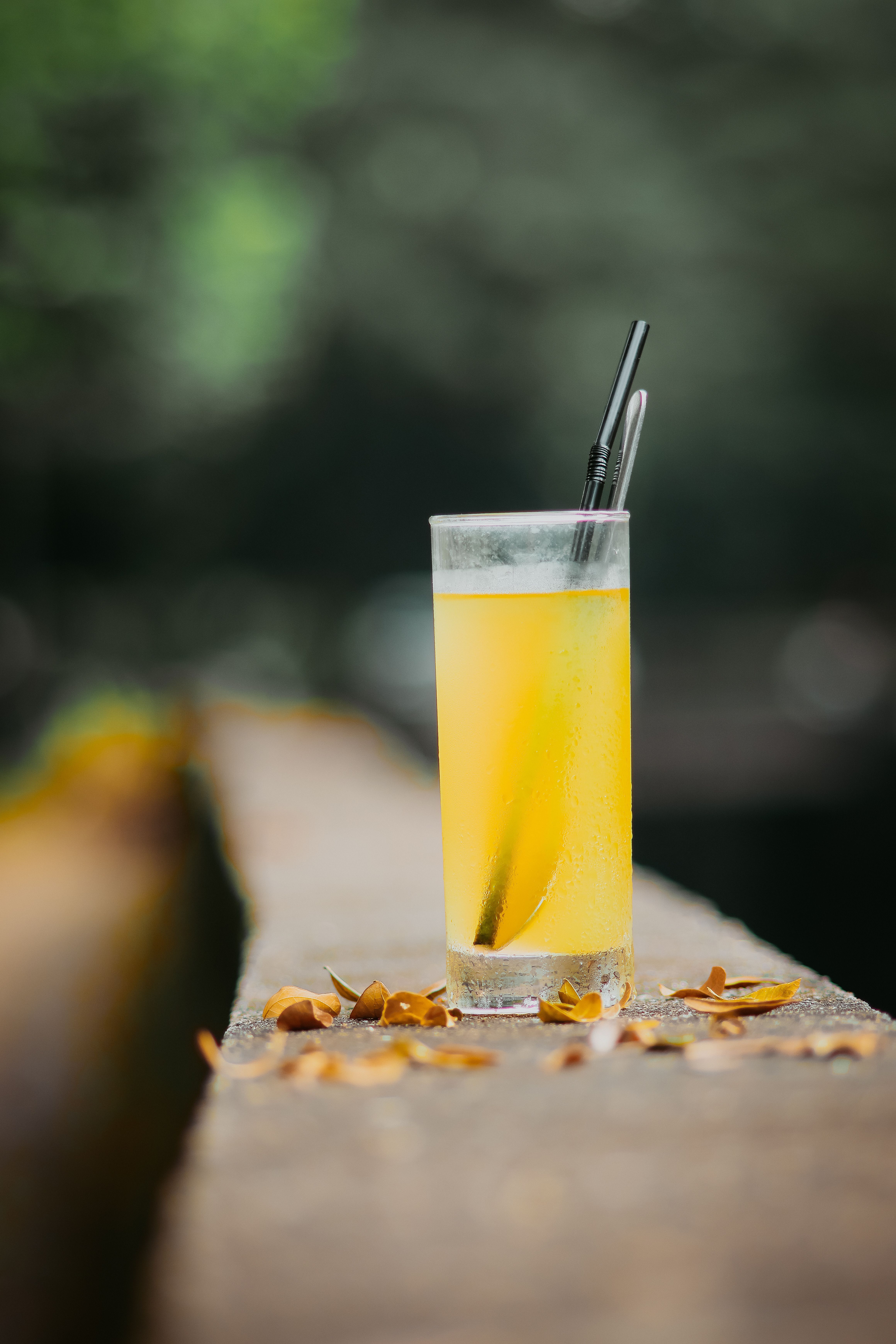 Refreshing Yellow Drink with Straw Outdoors · Free Stock Photo