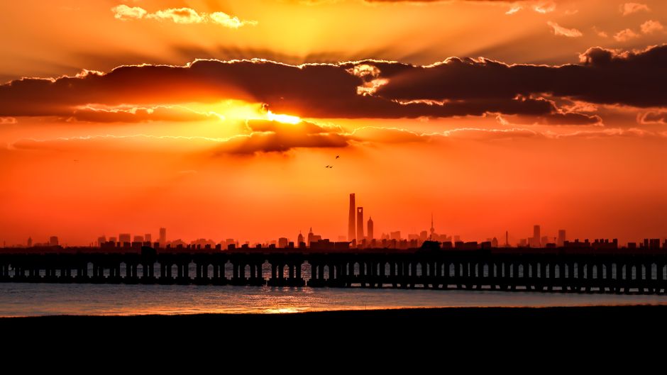 The vibrant Manama skyline at sunset, representing the exciting possibilities of a trip to Bahrain.