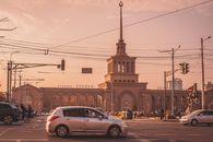 Stunning sunset view of the Yerevan Railway Station with bustling street and cars, Armenia.