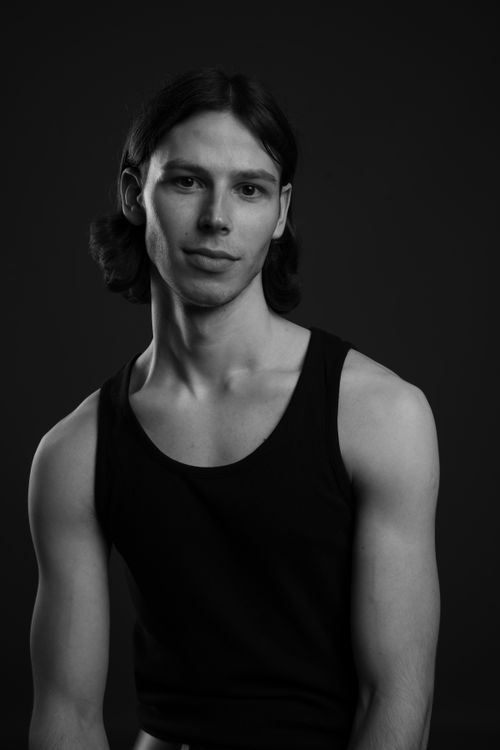 Free Striking black and white portrait of a young man in a studio setting, exuding elegance and poise. Stock Photo