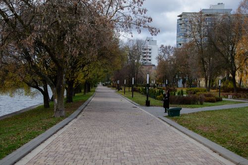 Free A serene autumn day on a pedestrian pathway beside the river in Minsk, Belarus. Stock Photo