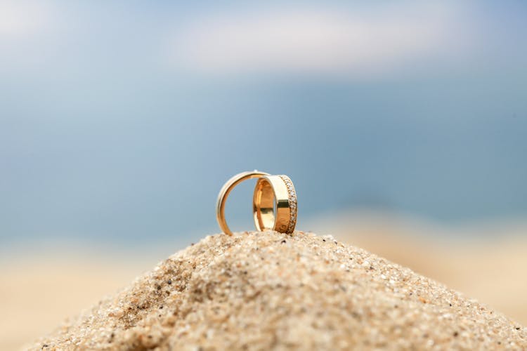 Gold Wedding Bands On Sand