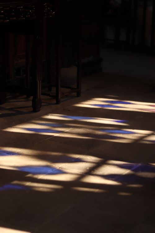 Free Colorful stained glass reflections create a magical pattern on a stone floor. Stock Photo
