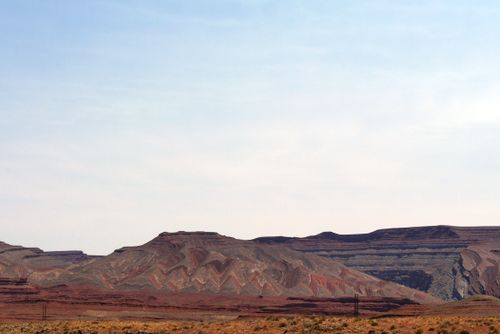 Free Beautiful desert landscape showcasing unique layered rock formations under a bright sky. Stock Photo