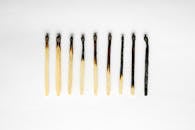 Burned Matches in a Symmetrical Layout on White Background