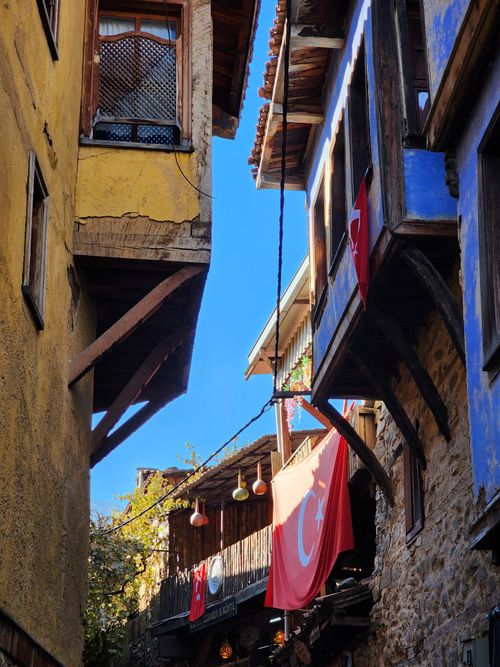 Free Charming alleyway in Bursa, Türkiye with Ottoman-style houses and Turkish flags. Stock Photo