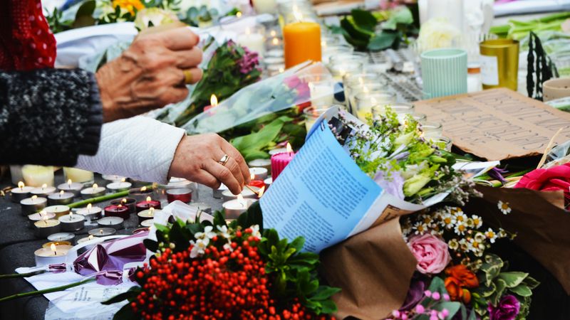 A touching scene of a memorial with flowers and candles.