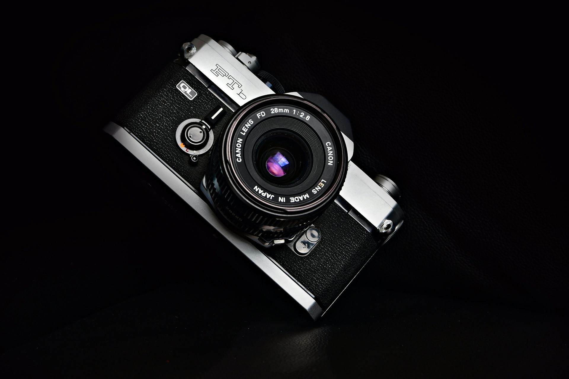 Vintage analog camera with a Canon FD lens, showcasing a retro photography vibe.