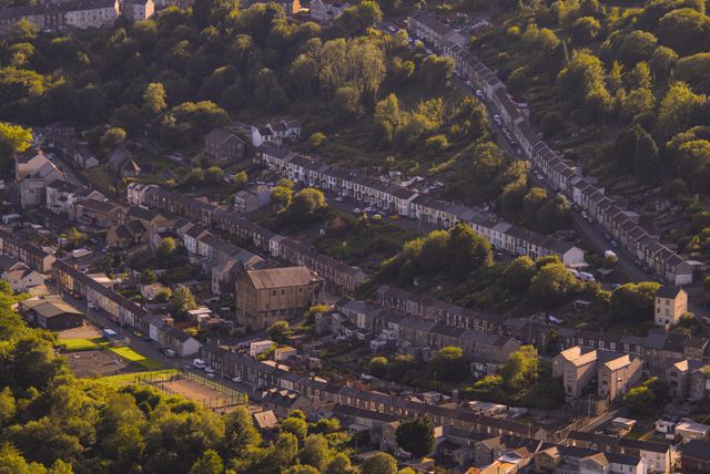 Aerial view of terraced houses in a Welsh valley, illustrating a portfolio acquisition scenario where multiple dwellings relief applies under Welsh LTT