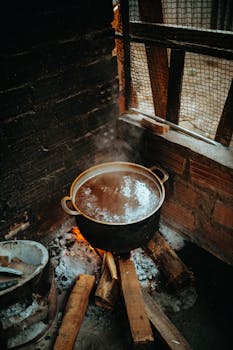 A steaming pot on an open fire in a traditional Vietnamese kitchen.