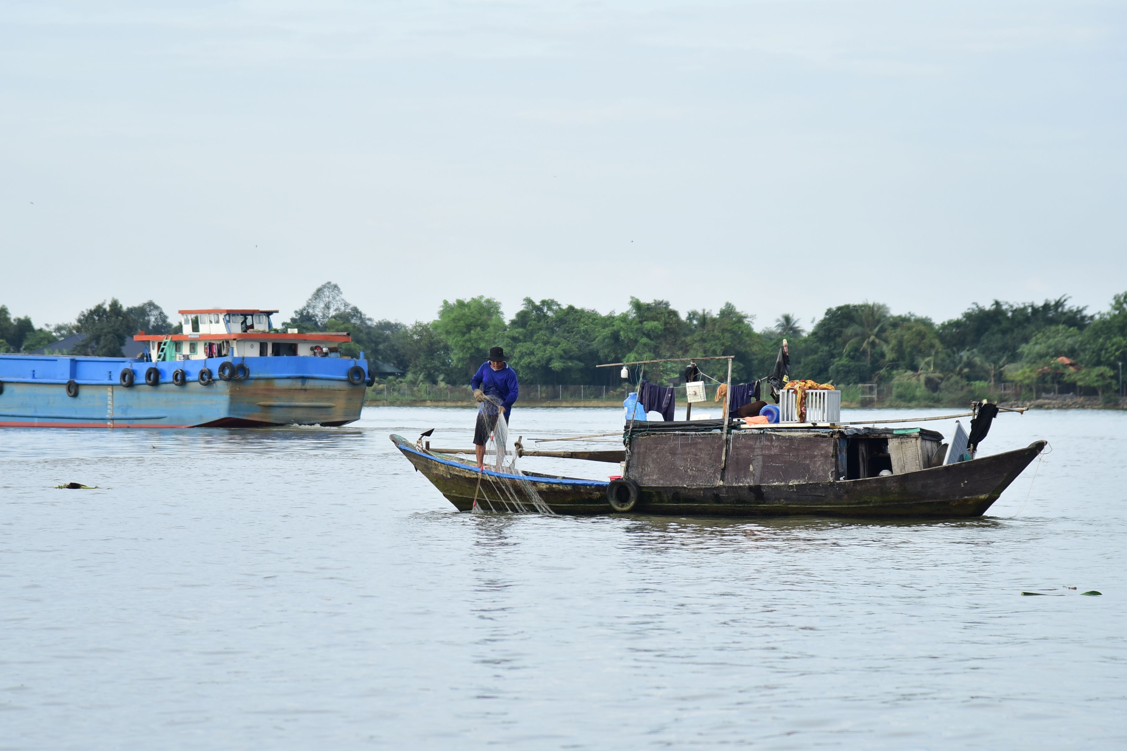 A small boat on calm river waters at sunrise