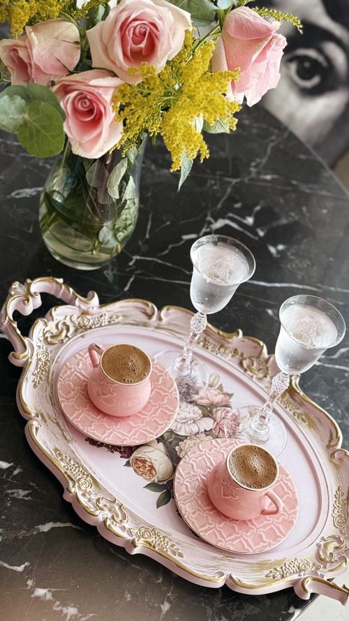 Free Delicate tea setup with pink roses and coffee cups on a floral tray. Stock Photo
