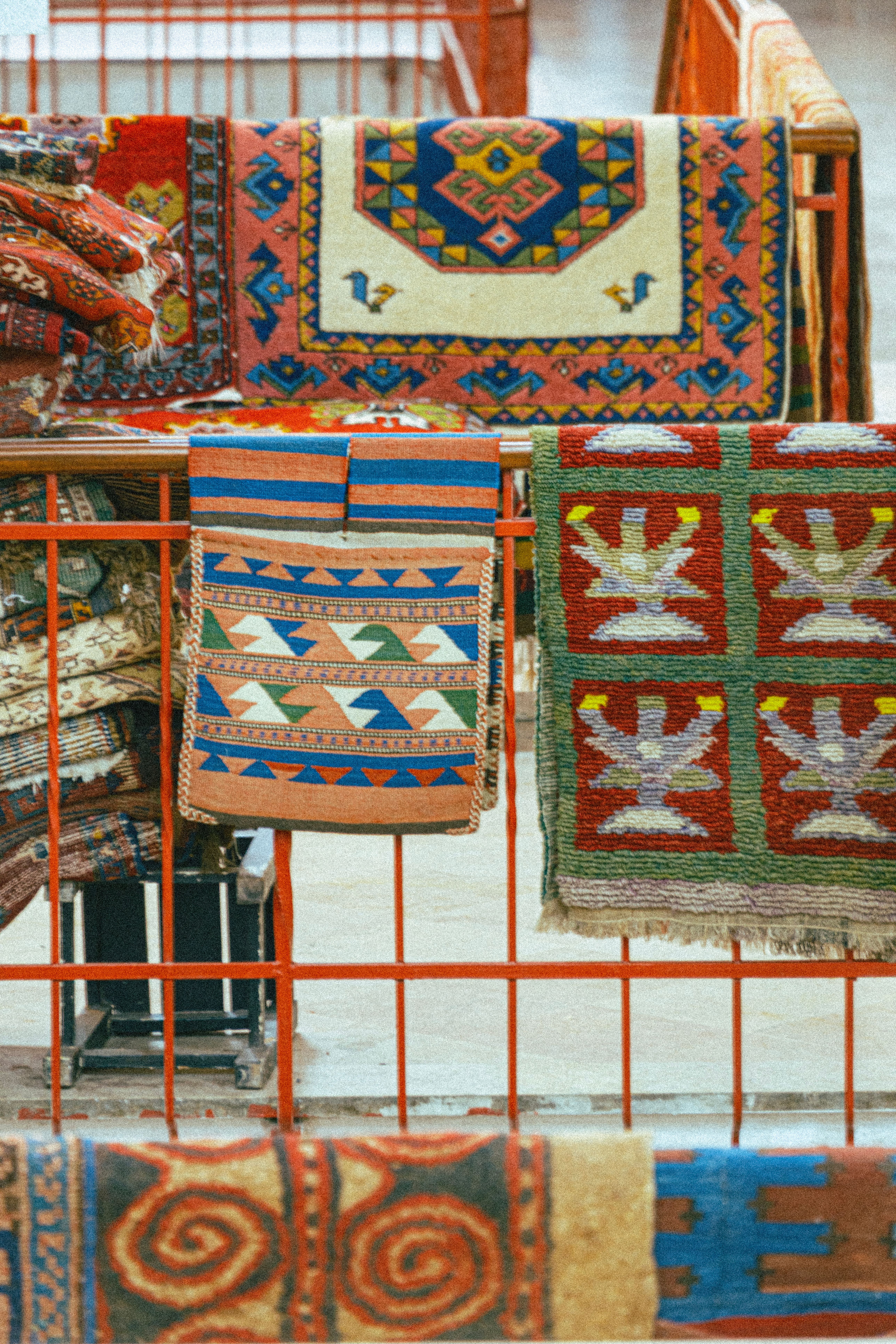 Colorful Display of Traditional Woven Rugs · Free Stock Photo