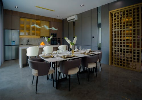 A beautifully designed dining area with a modern kitchen, showcasing elegance and style.