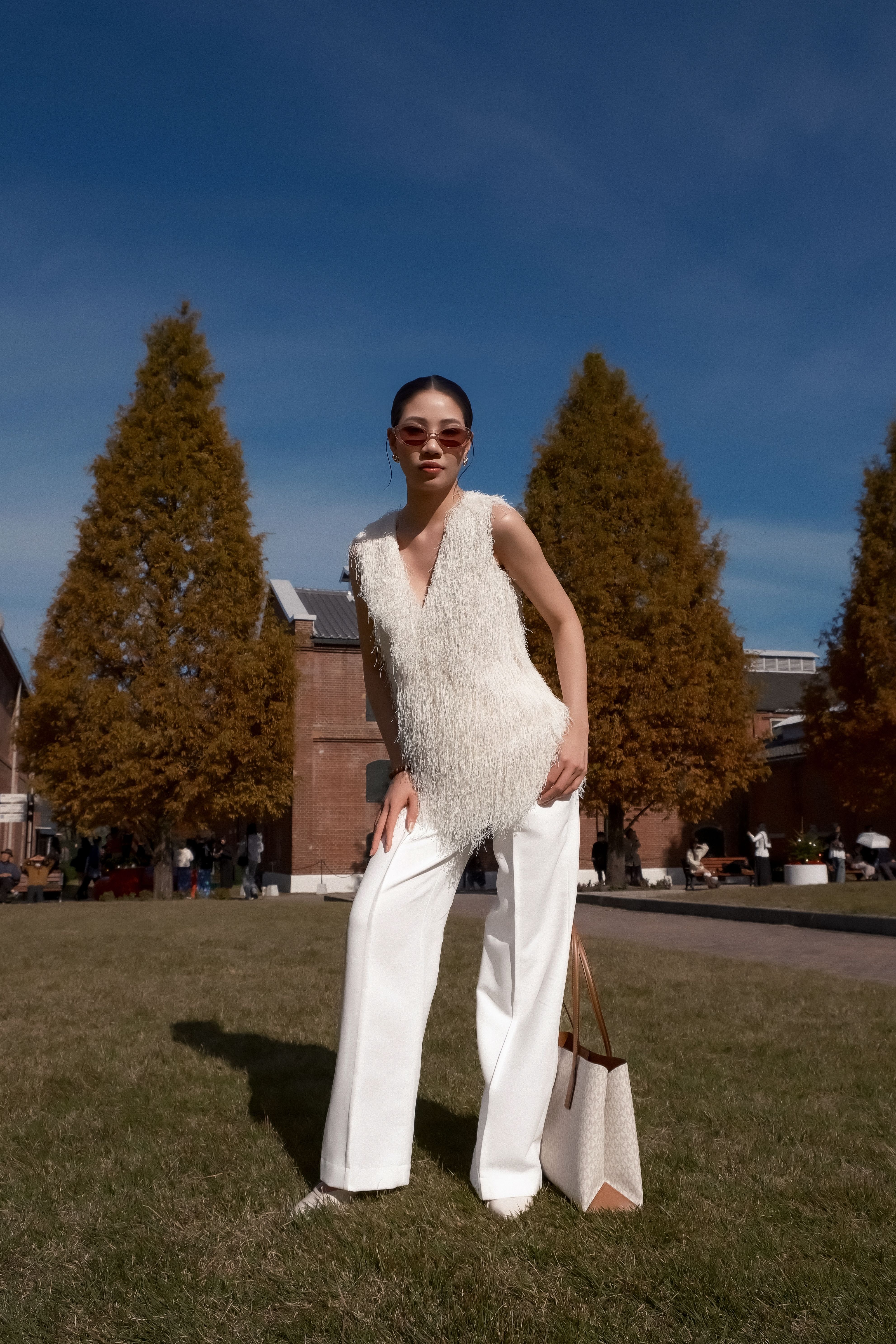 Stylish Woman Posing in Outdoor Autumn Setting · Free Stock Photo