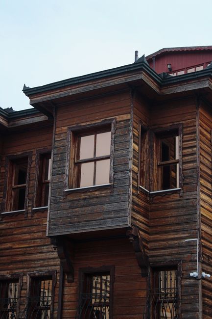 Photo by Emre on Pexels Close-up of a rustic wooden house facade featuring multiple windows and weathered texture.
