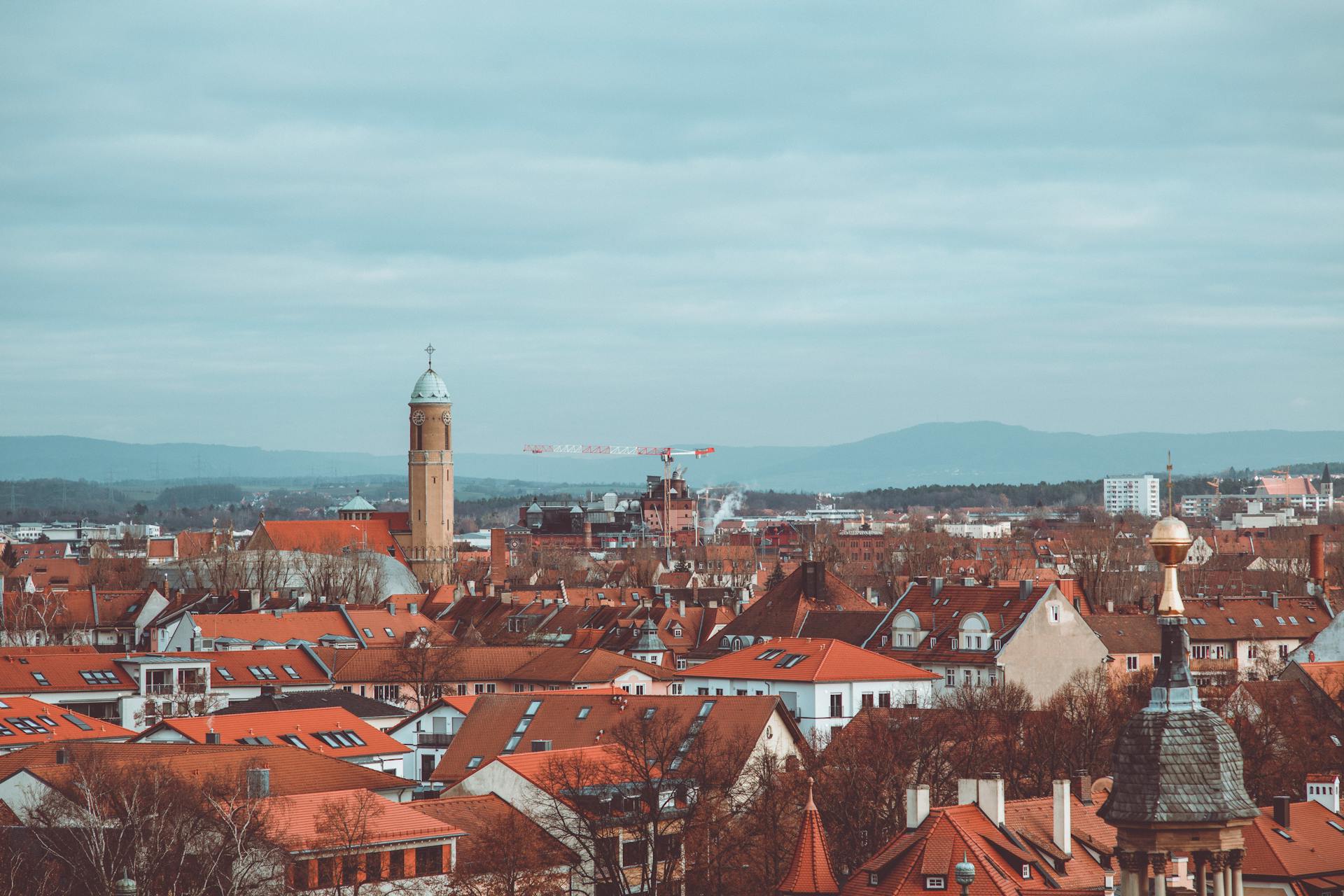 Explore the charming red rooftops of historic Bamberg under a cloudy sky. A scenic blend of architecture and culture.