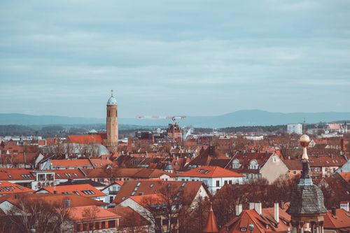 Free Explore the charming red rooftops of historic Bamberg under a cloudy sky. A scenic blend of architecture and culture. Stock Photo