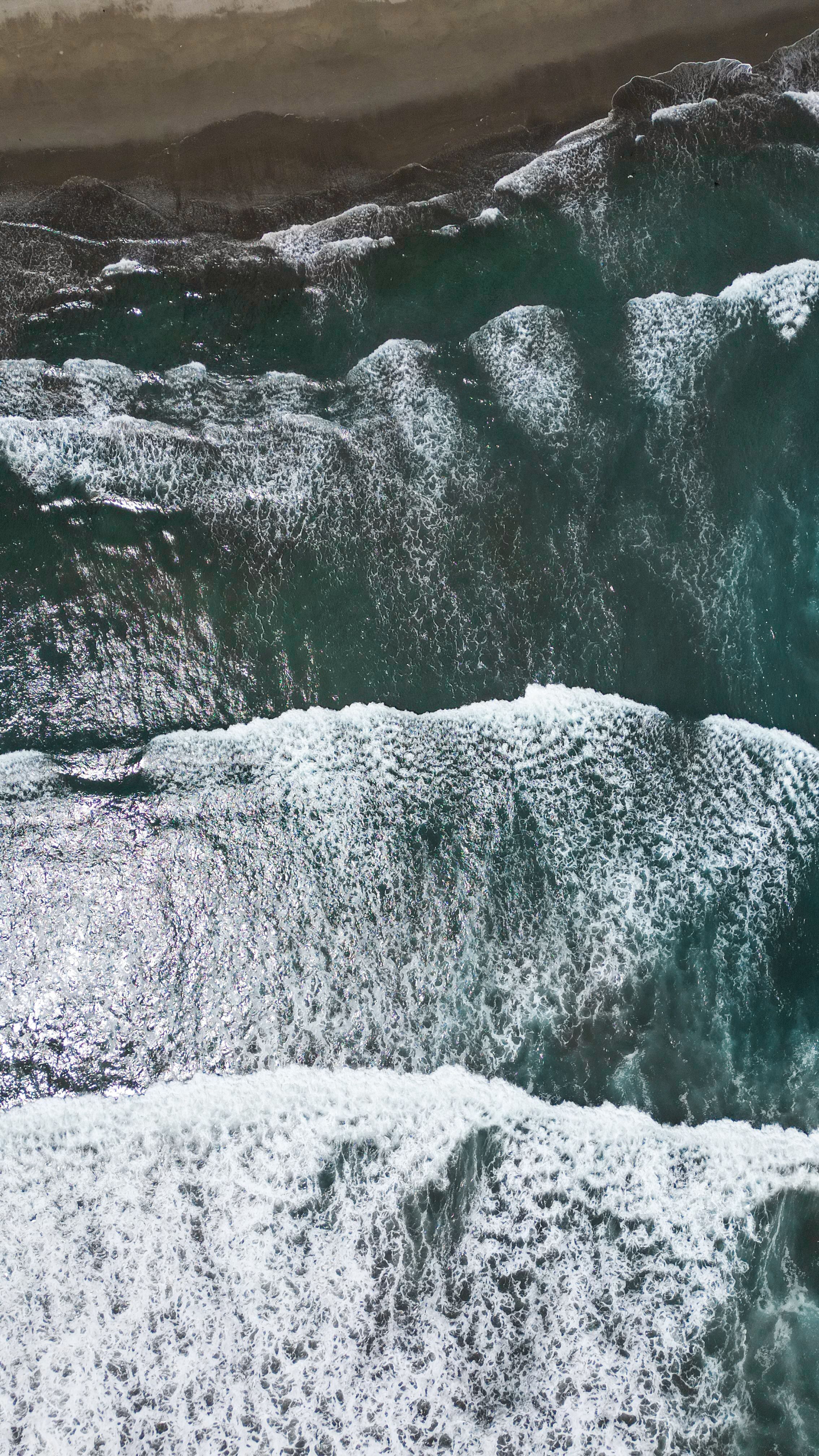 Aerial View of Ocean Waves Crashing on Shore · Free Stock Photo