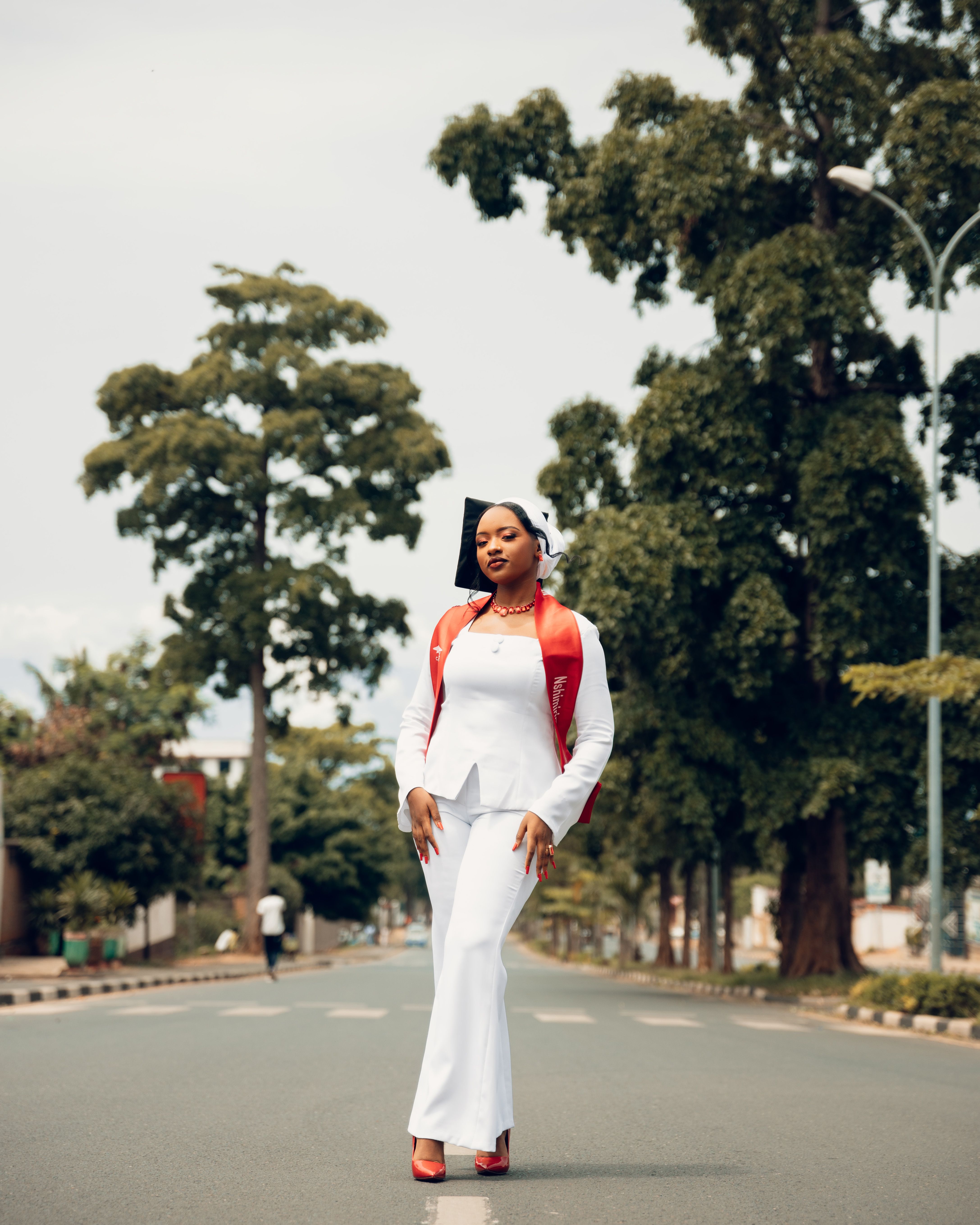 Stylish Woman Walking on Tree-Lined Urban Street · Free Stock Photo