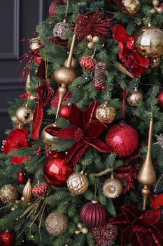 Elegant Christmas tree adorned with red and gold decorations capturing holiday spirit.