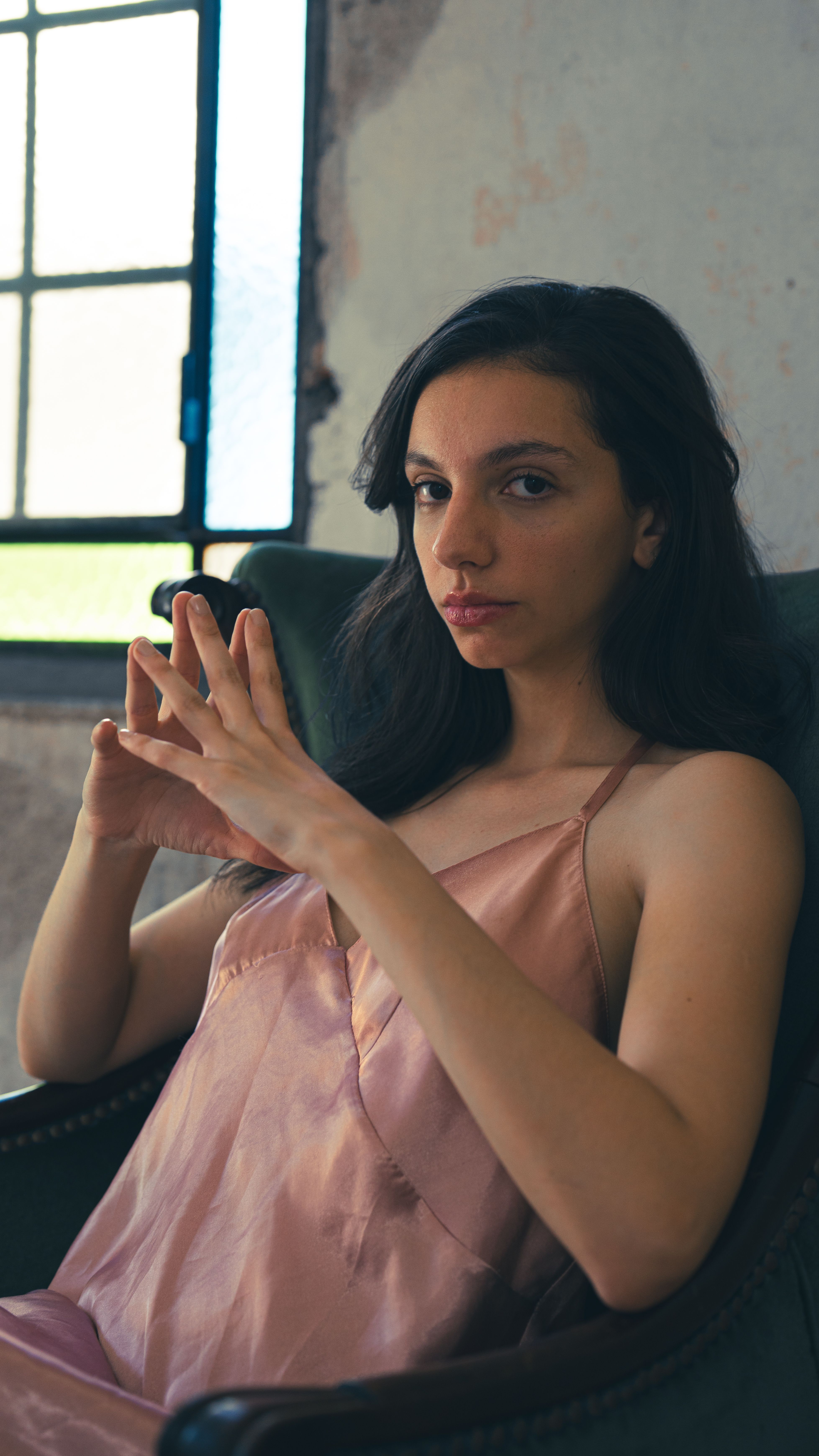 Elegant Woman in Pink Dress Sitting Indoors · Free Stock Photo