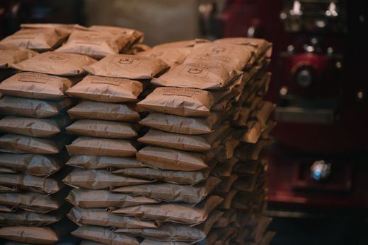 Stacked brown paper coffee packages — photo by Alinson Torres on Pexels