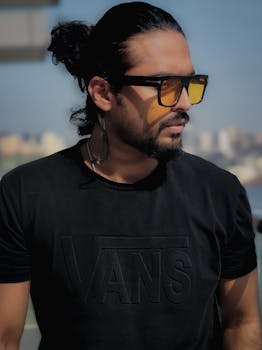 Casual portrait of a man with sunglasses against Dubai skyline.