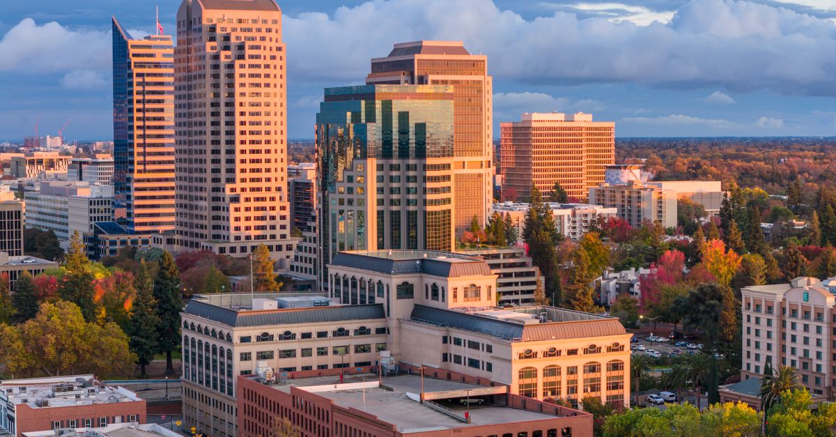 A stunning view of downtown Sacramento's skyline bathed in warm sunset light.