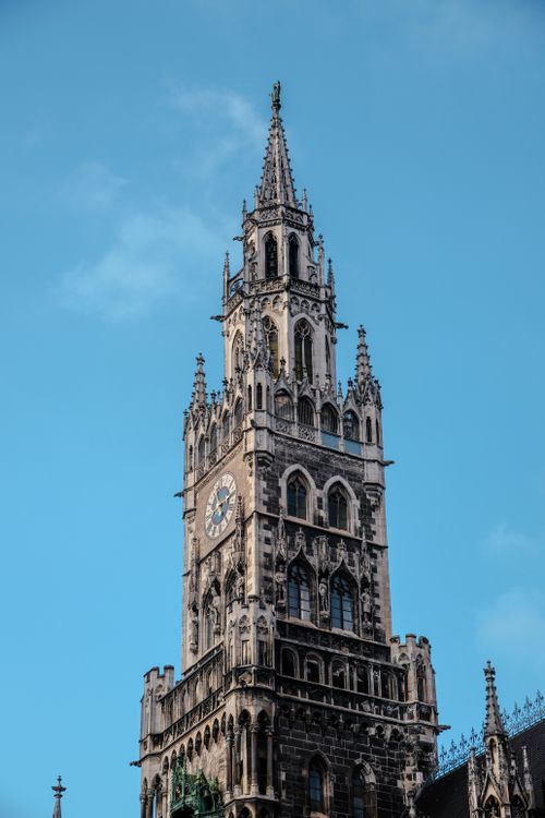 Free Stunning Gothic clock tower ascends against a clear blue sky. Stock Photo
