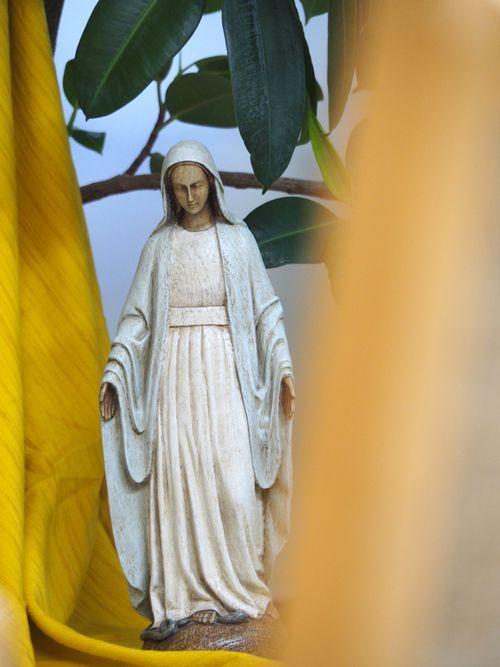 Free A serene statue of the Virgin Mary surrounded by greenery and vibrant colors in Sherbrooke, Québec. Stock Photo