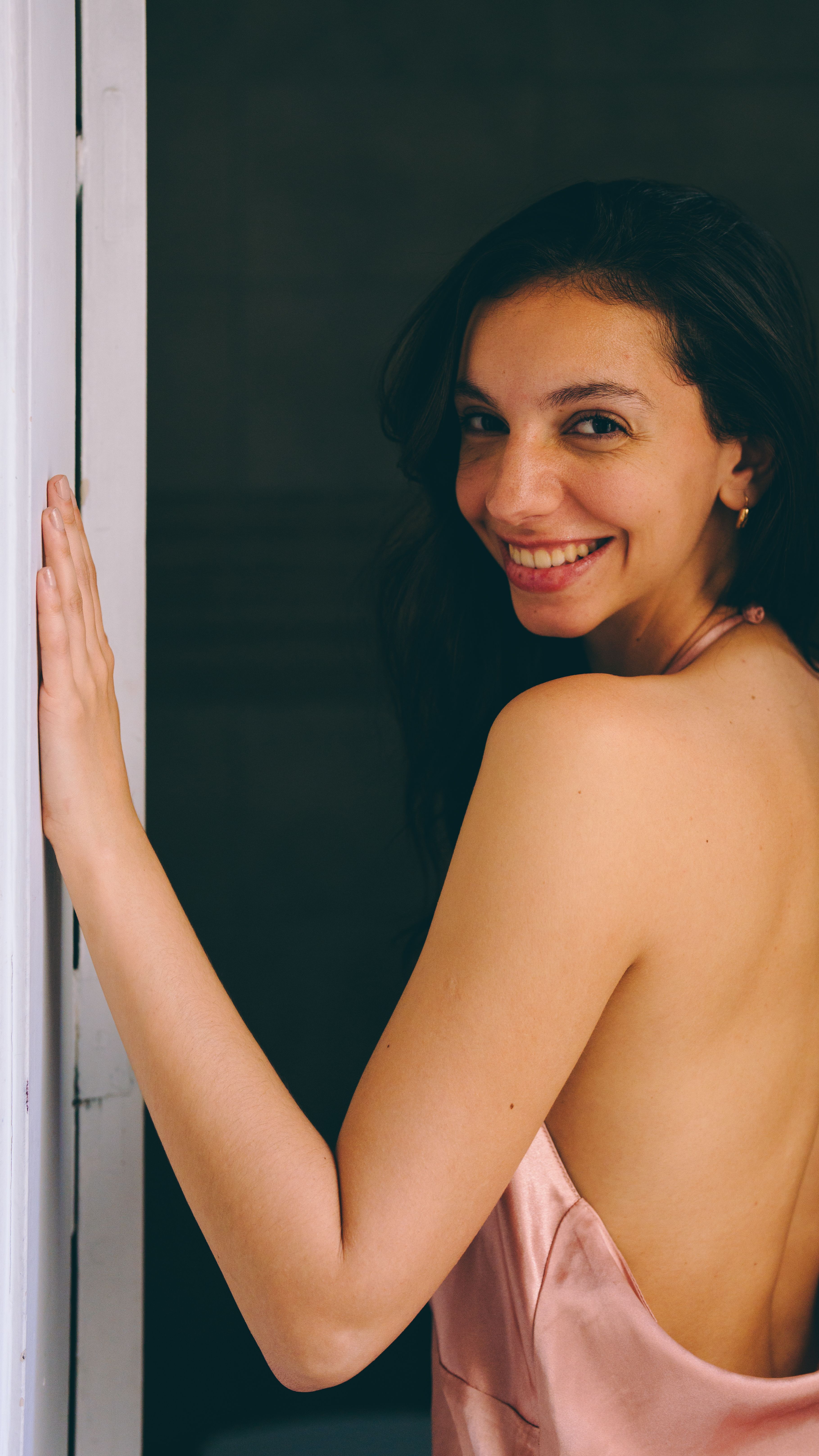 Smiling Woman in Elegant Pink Dress Indoors · Free Stock Photo