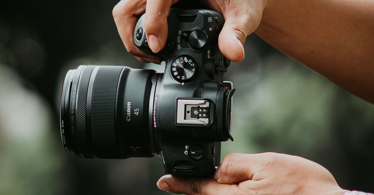 Hand Position Camera Close-up of Hands Holding a Modern Camera · Free Stock Photo