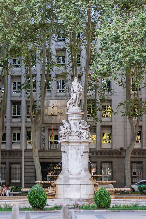 Free Elegant marble statue in Plaza de la Villa, surrounded by trees in Madrid, Spain. Stock Photo