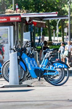 Blue BiciMad bicycles parked at a station in sunny Madrid, perfect for city exploration.