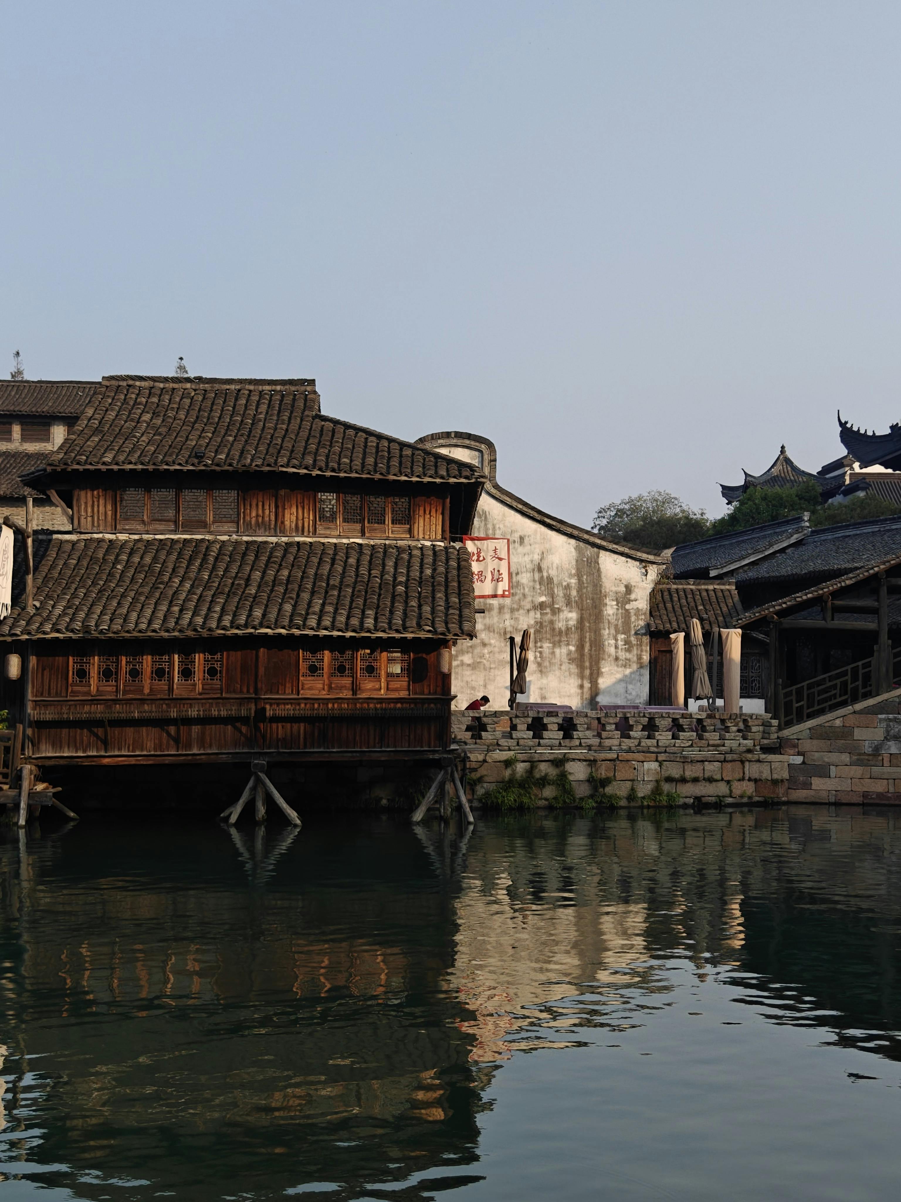 Scenic view of traditional Chinese architecture reflecting in calm water.