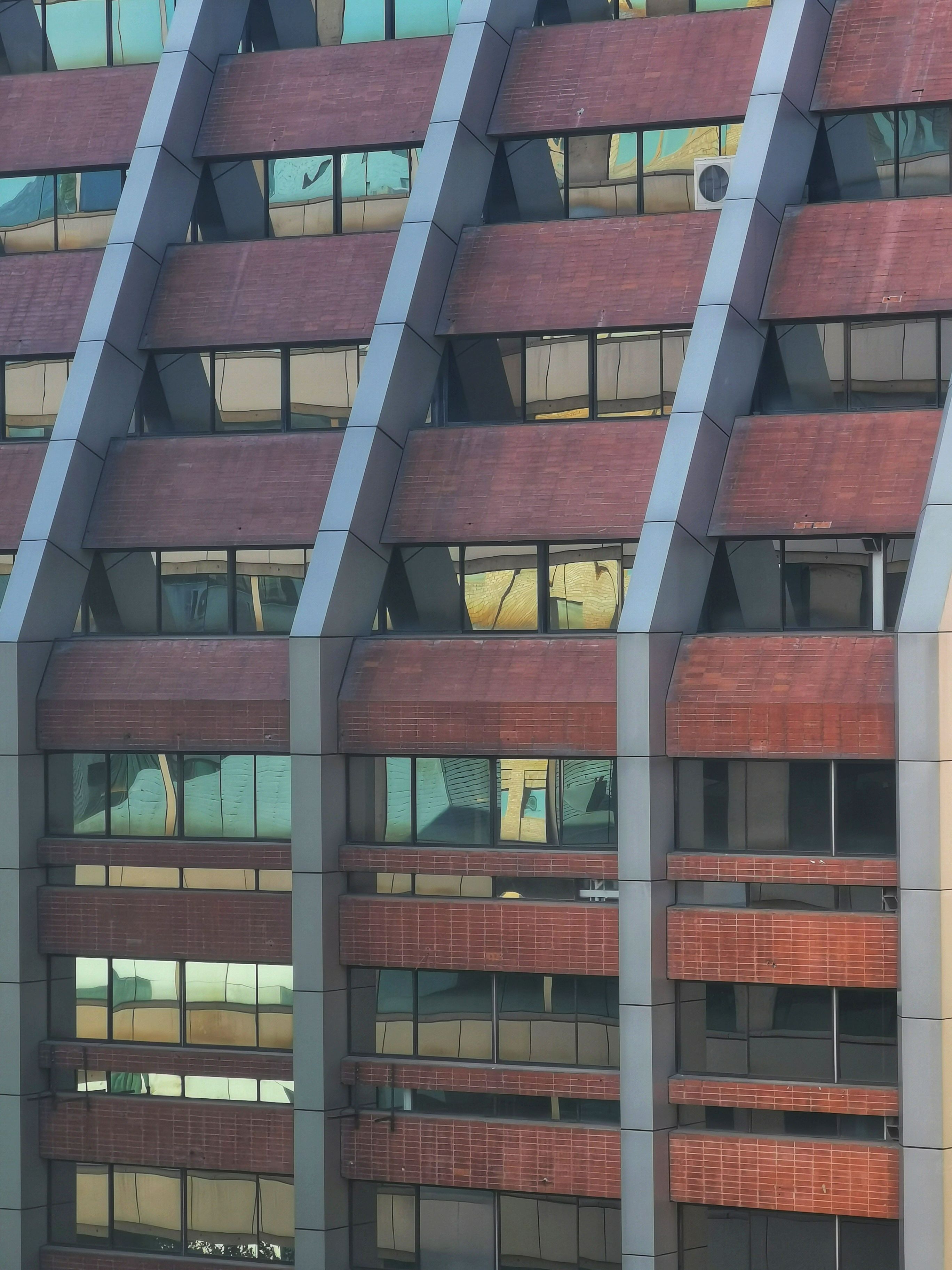 Modern Architectural Facade with Glass Windows · Free Stock Photo