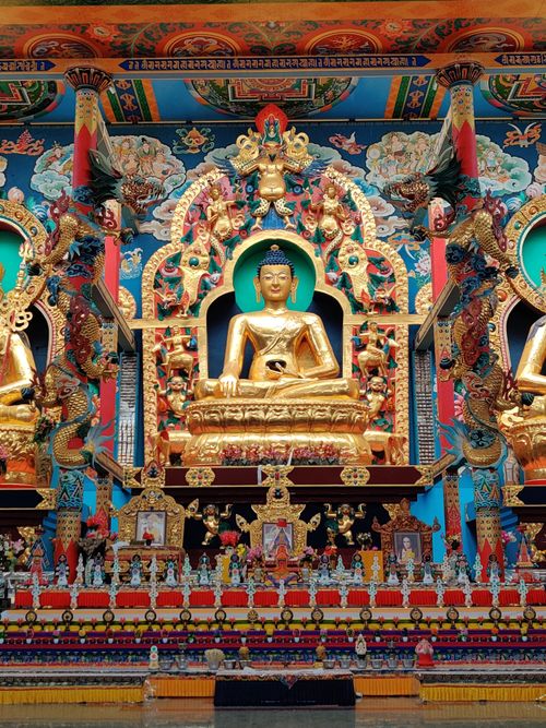 Free Vibrant and detailed view of a golden Buddha statue inside a Tibetan temple in Bylakuppe, India. Stock Photo
