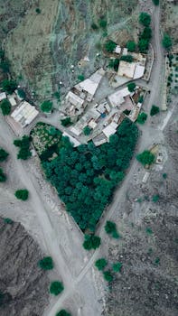 Stunning aerial shot of a heart-shaped farm nestled in Oman's rugged mountains.