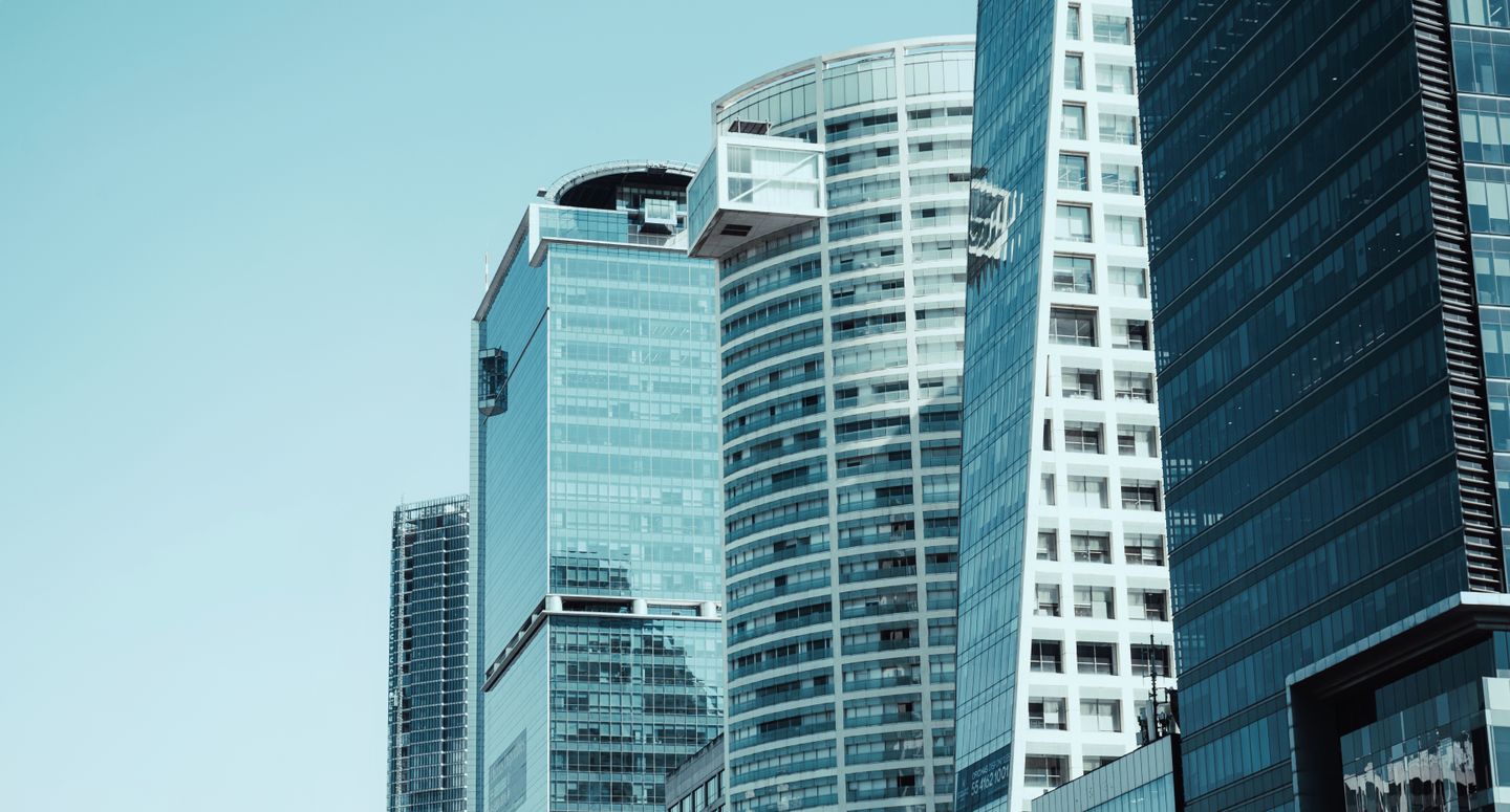 Modern glass and steel high-rise buildings in downtown Los Angeles against clear blue sky