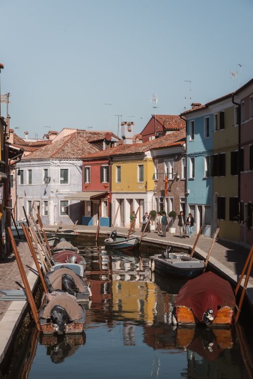 Free A serene canal scene with vibrant, colorful houses in Burano, Italy. Stock Photo