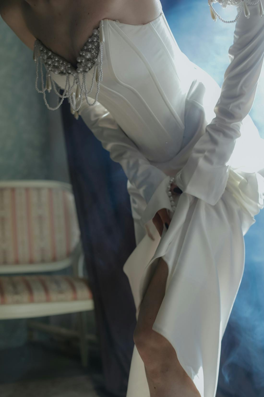 Close-up of an embellished white evening gown neckline