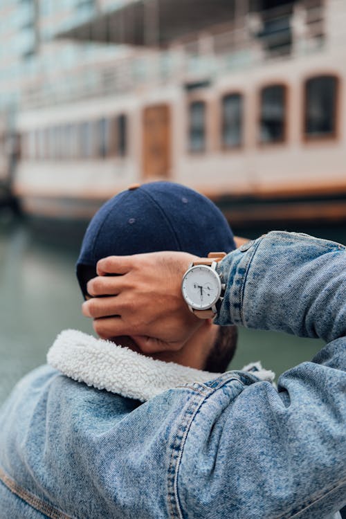 Free Person Wearing Blue Denim Jacket and Silver Round Analog Watch Stock Photo
